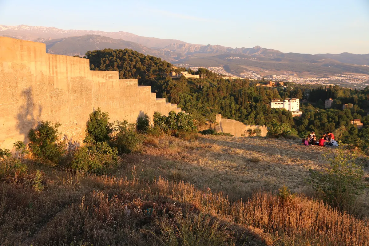 Sacromonte tepesinin zirvesinde bir Mağribi duvarı üzerinde akşam ışığı, uzakta Sierra Nevada